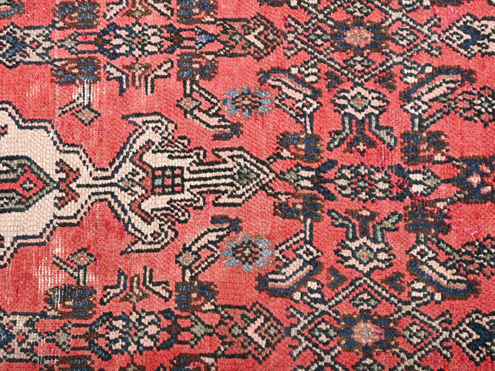 a red rug with a pattern on it