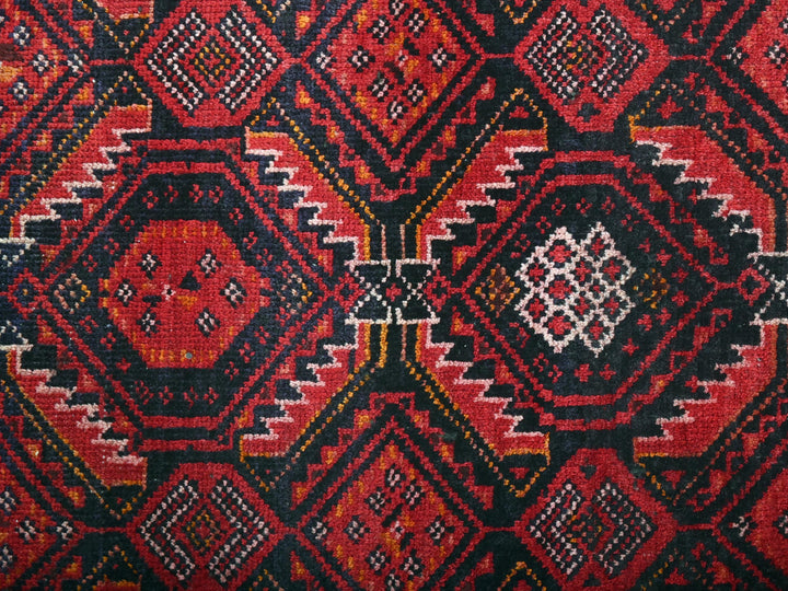a close up of a red and black rug