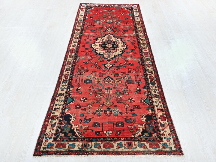 a long red rug on a white floor