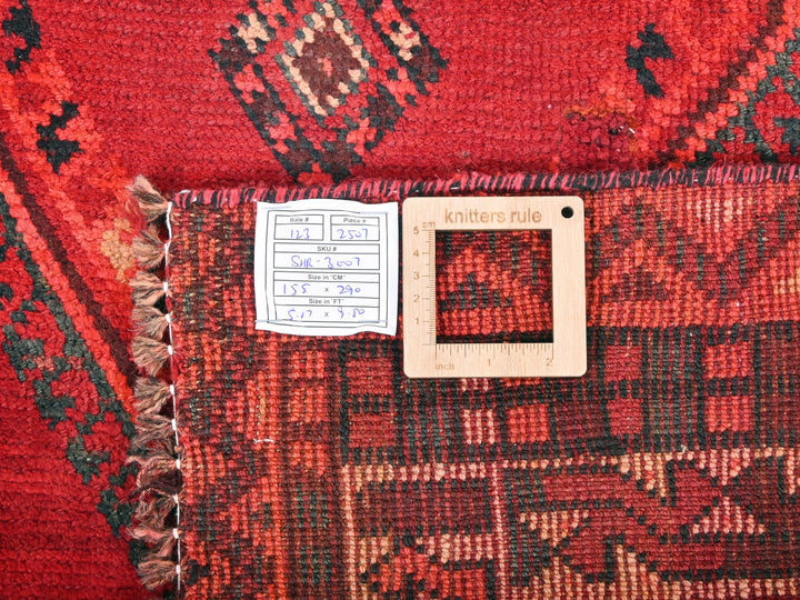 a red rug with a white tag on it