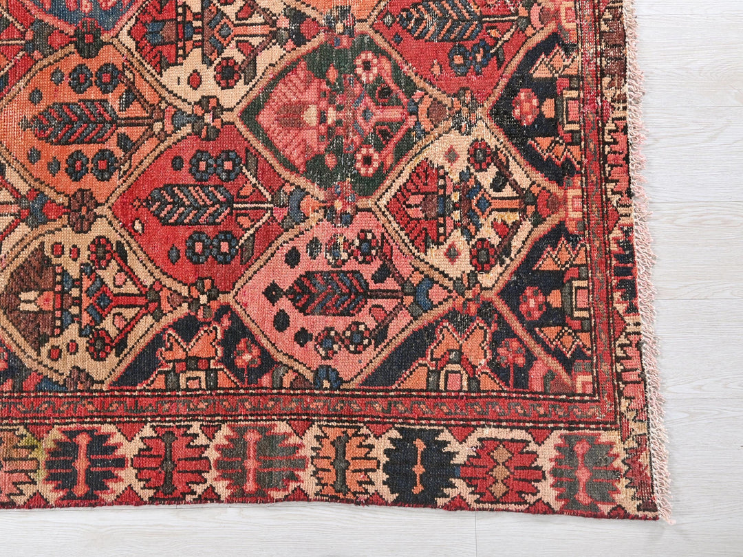 a red and blue rug on a white floor