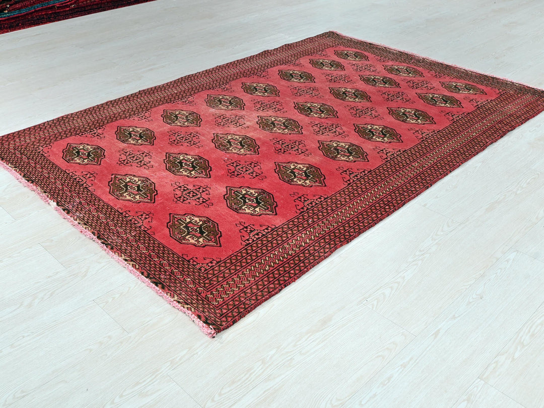 a red area rug on a white floor