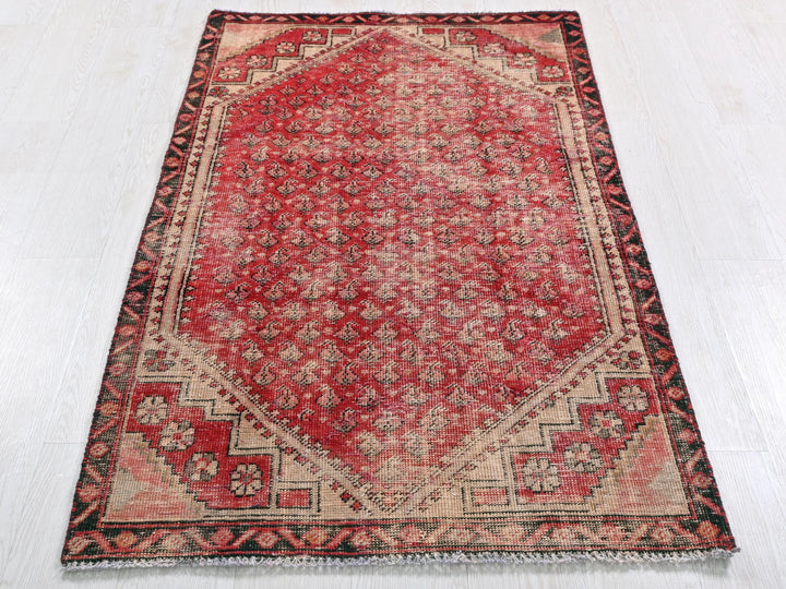 a red and black oriental rug on a white floor