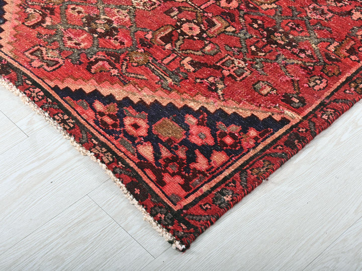 a red oriental rug on a white floor