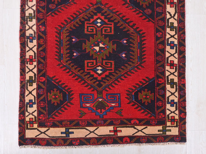 a red rug with a design on it