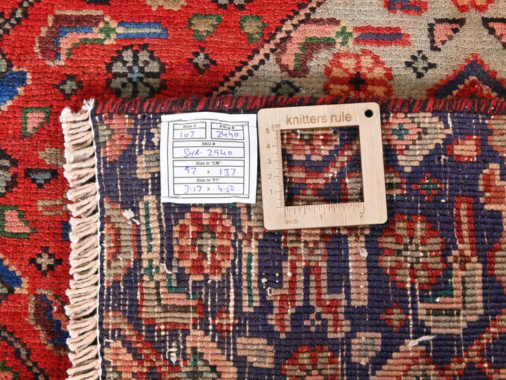 a pile of colorful rugs with a price tag