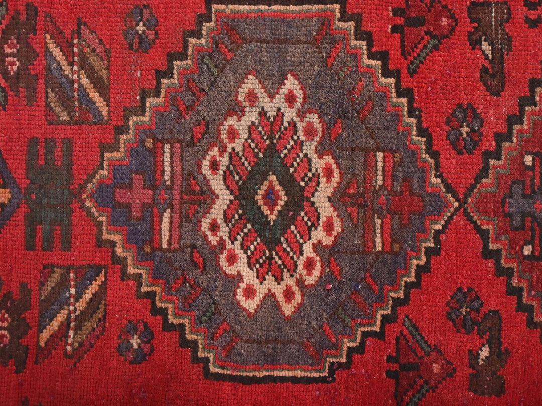 a close up of a rug with a red background