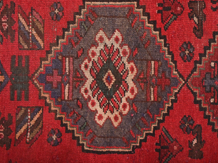a close up of a rug with a red background