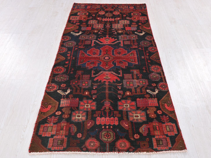 a red and black rug on a white floor