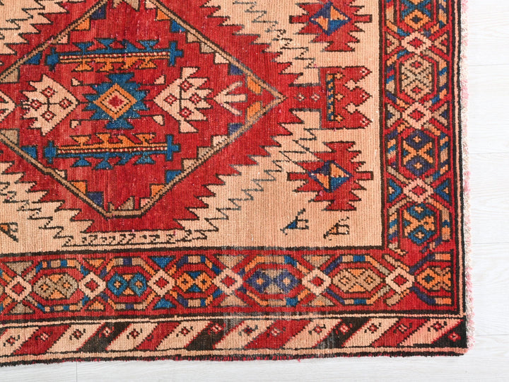 a red and blue rug on a white surface