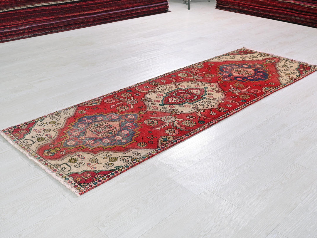 a red rug on a white floor in a room