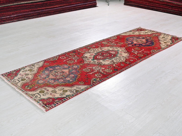 a red rug on a white floor in a room