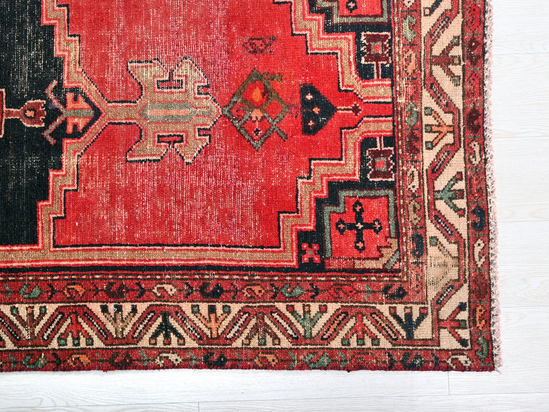 a red rug with a black border on a white background