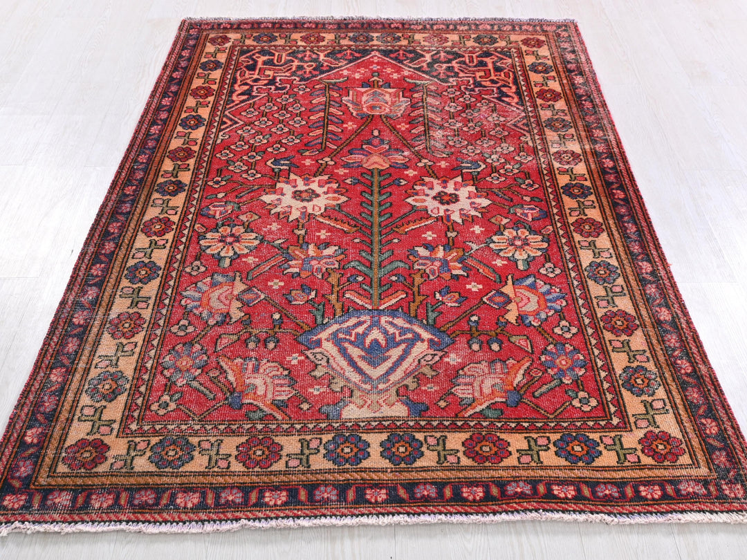 a red rug with a blue and red design on it