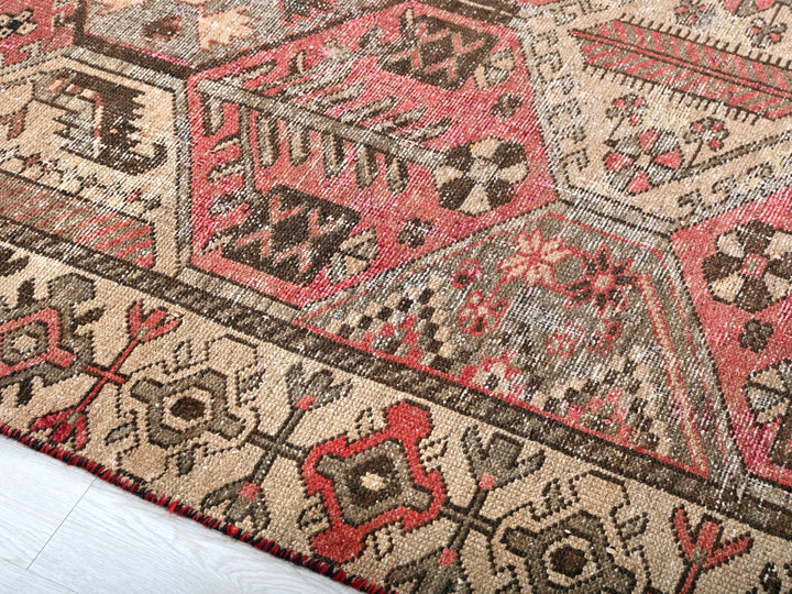 a red and brown oriental rug on a white floor