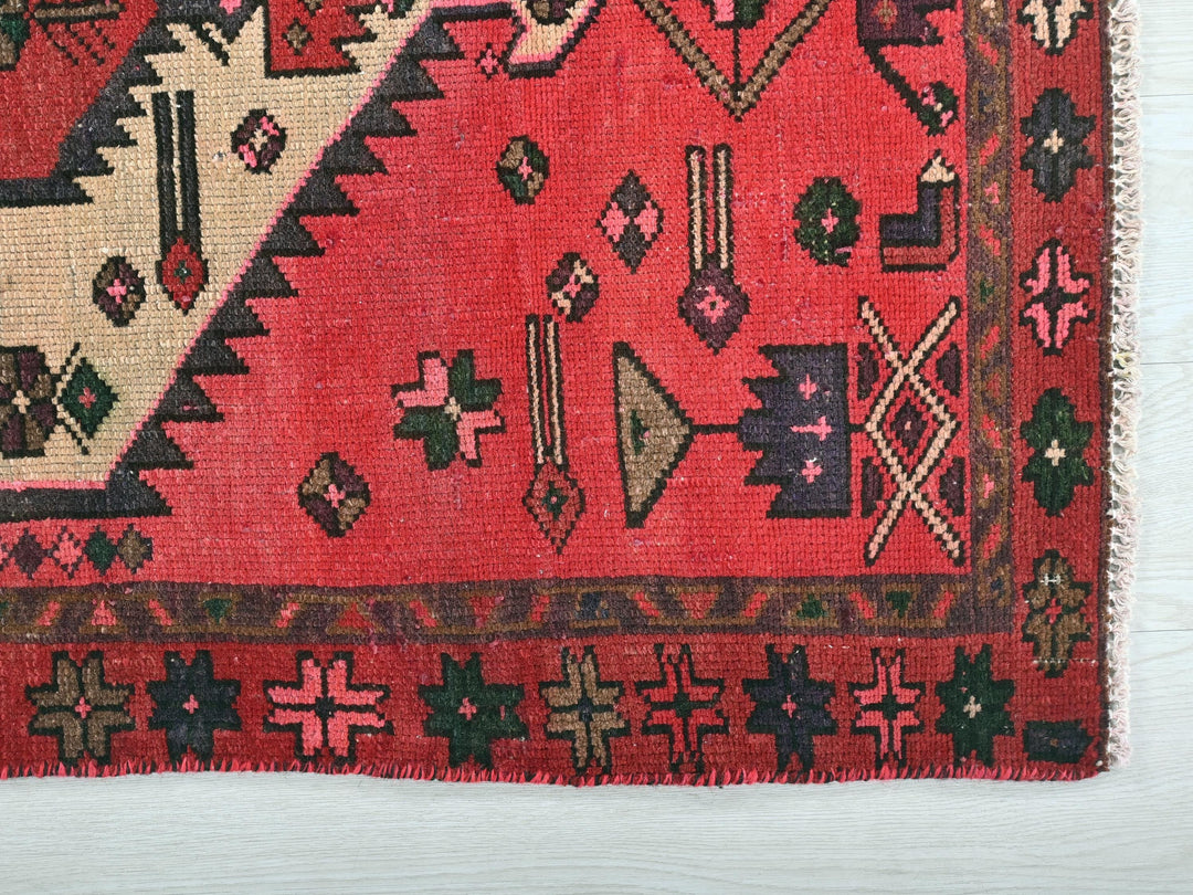 a red rug with a design on it