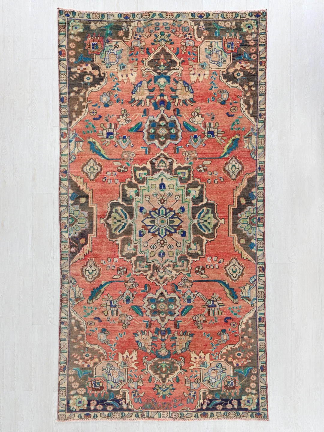 a red rug with an intricate design on it