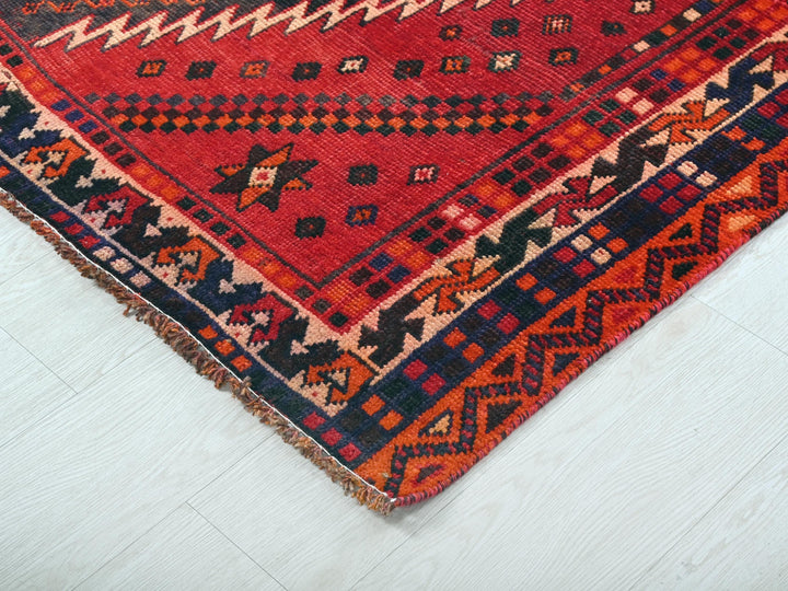 a red and blue rug on a white floor
