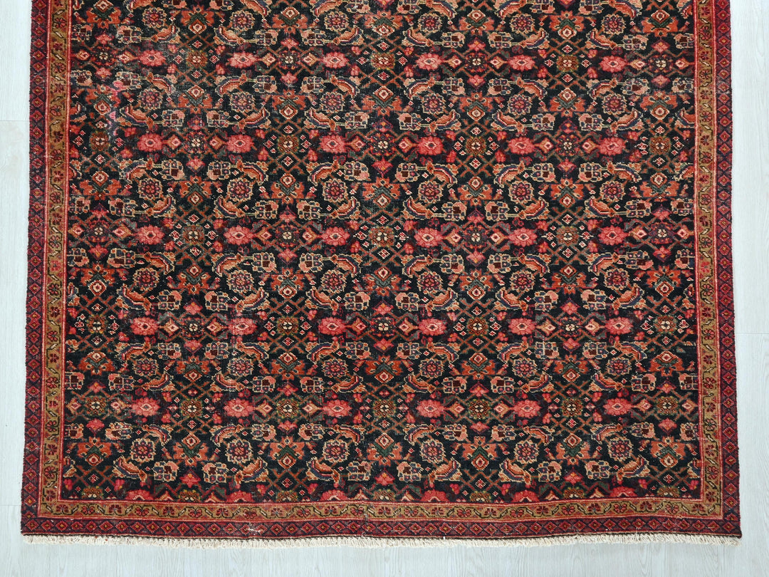 an antique persian rug with a floral design