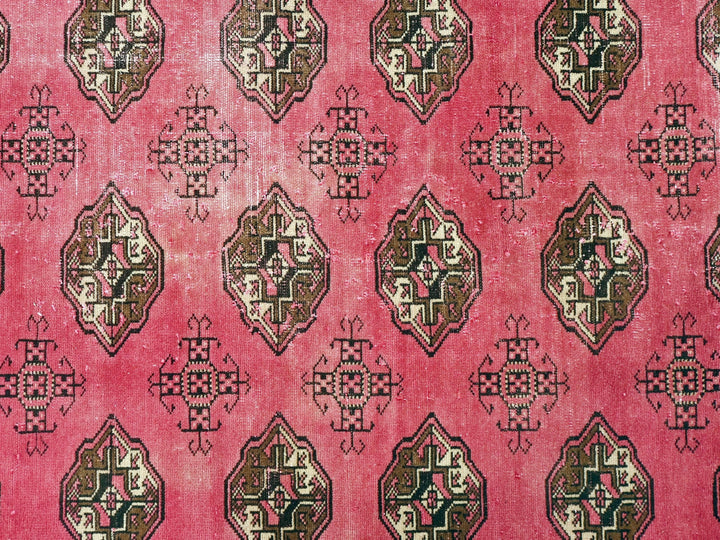 a red rug with a design on it