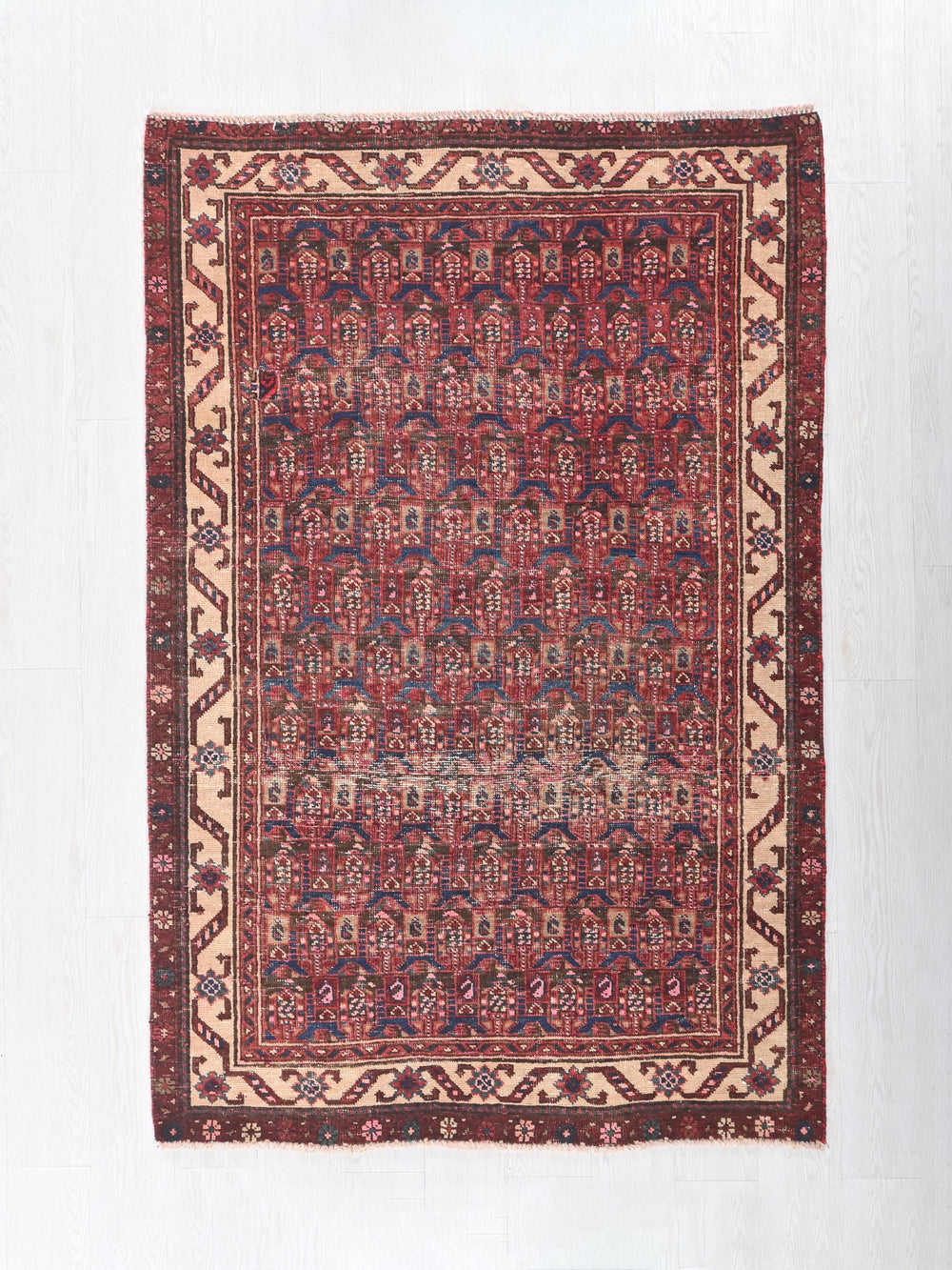 a red and blue rug with a design on it