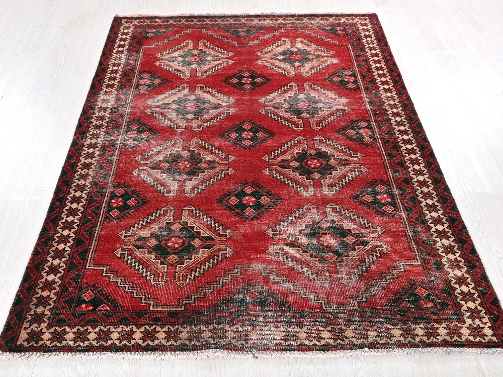 a red rug with a diamond pattern on it