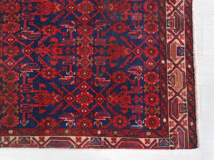 a red and blue rug on a white surface