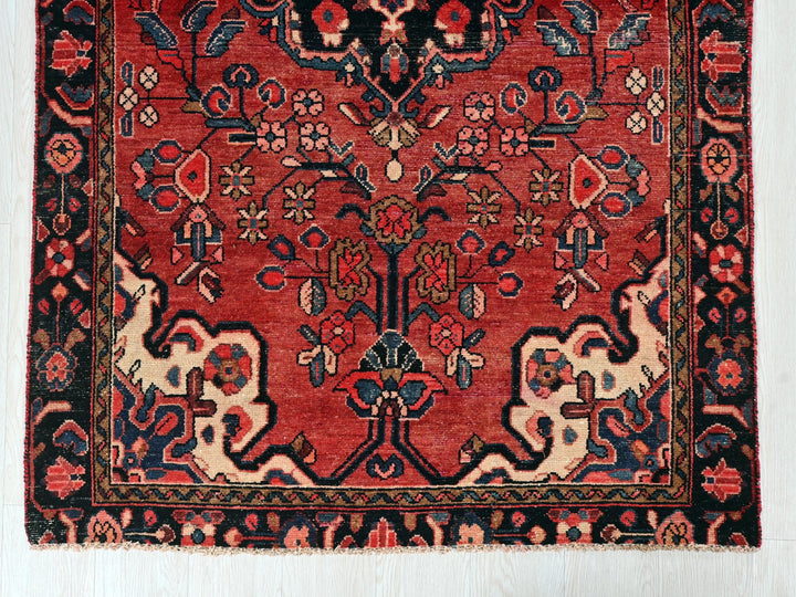a red rug with an intricate design on it