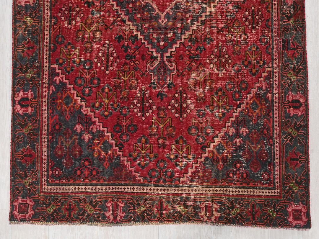 a red rug with a diamond pattern on it