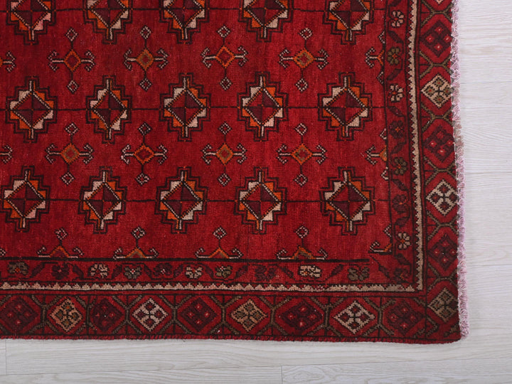 a red rug on a white wooden floor
