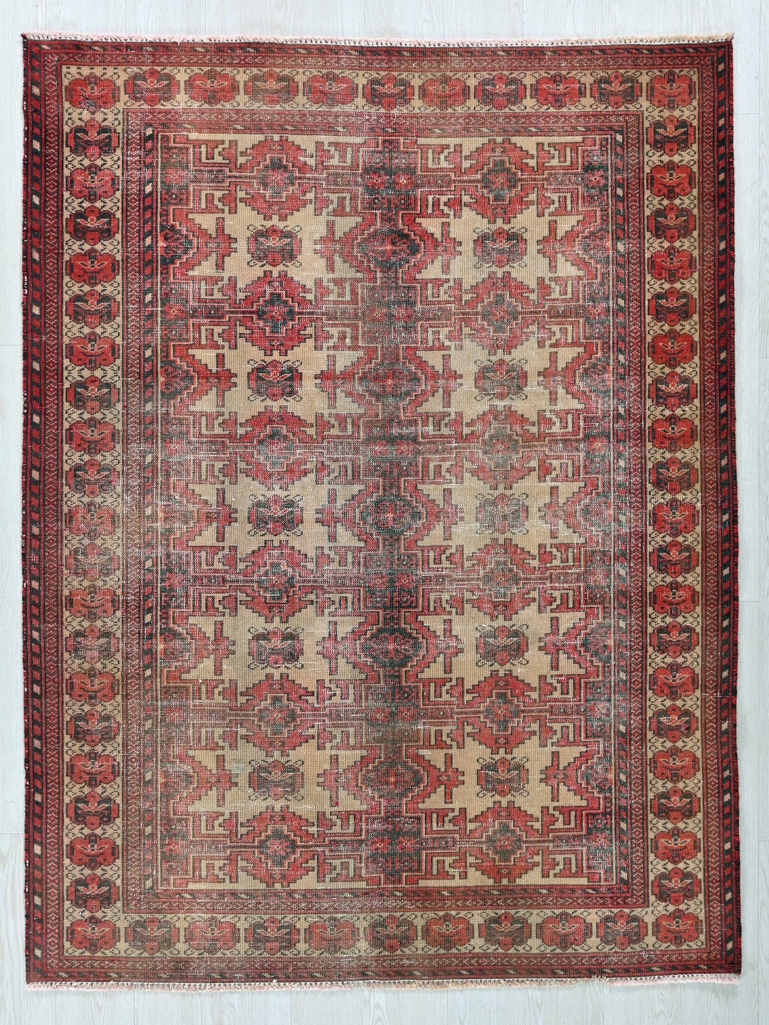 a red and beige rug with a design on it