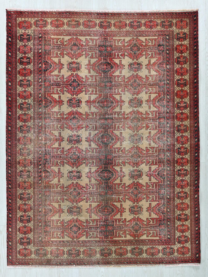 a red and beige rug with a design on it