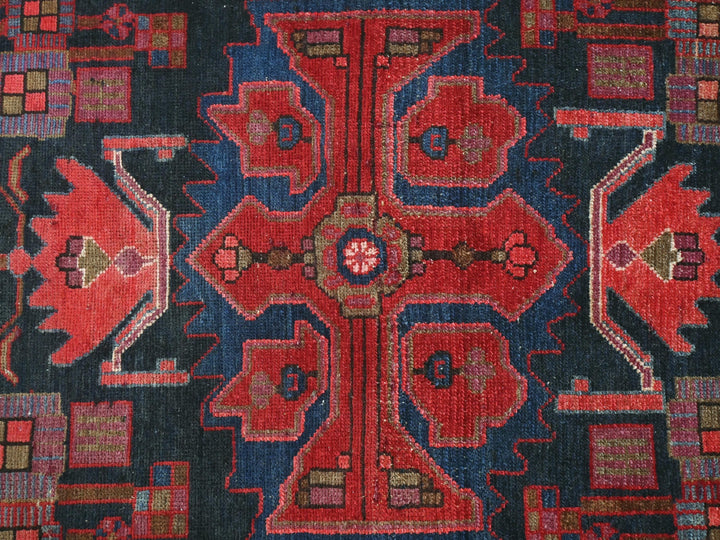 a red, blue, and black rug with a design on it