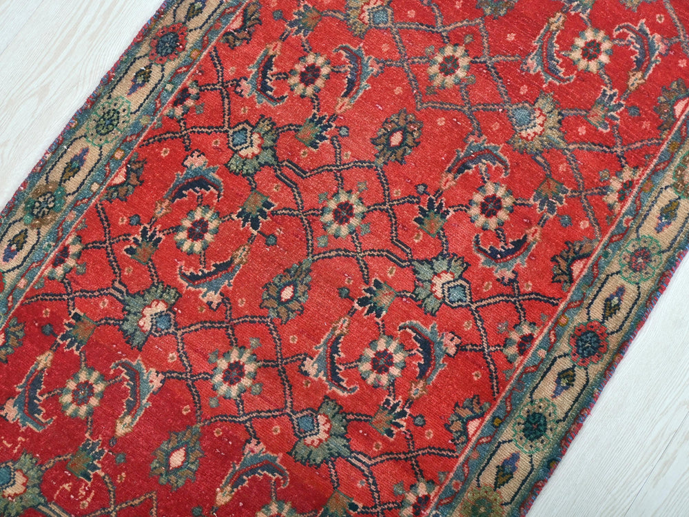 a red rug on a white wooden floor