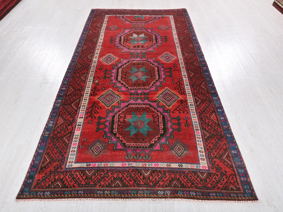 a red rug on the floor of a room