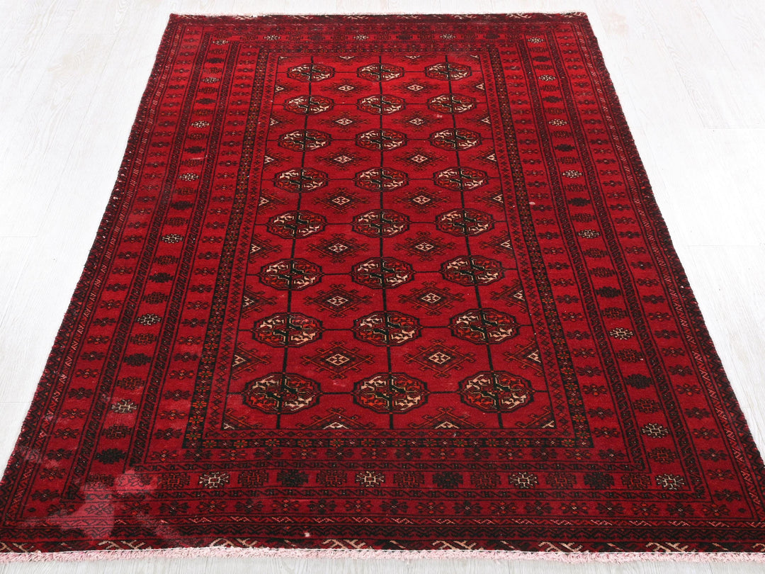a red oriental rug on a white floor