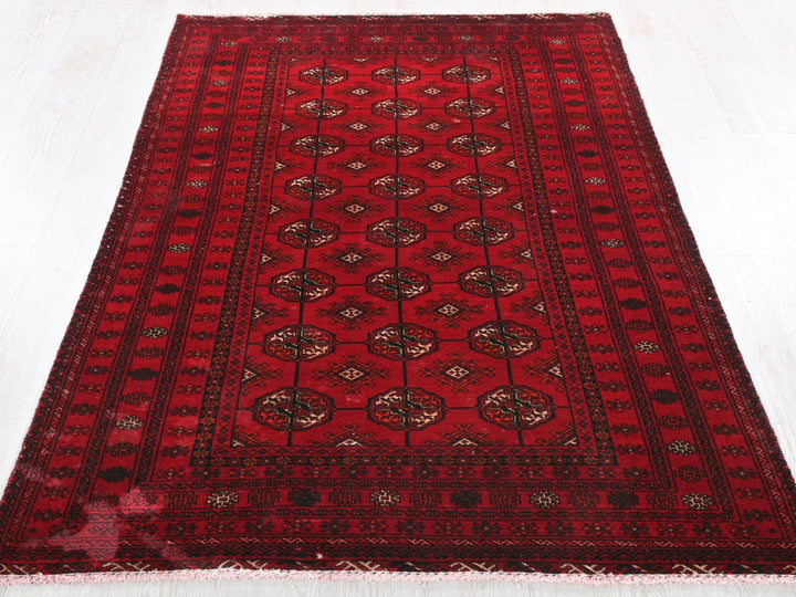 a red oriental rug on a white floor