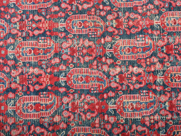 a red and blue rug with a floral design