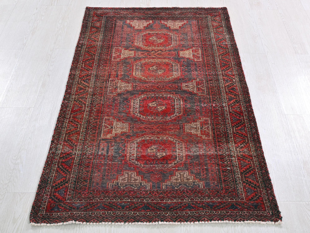 a red oriental rug on a white floor