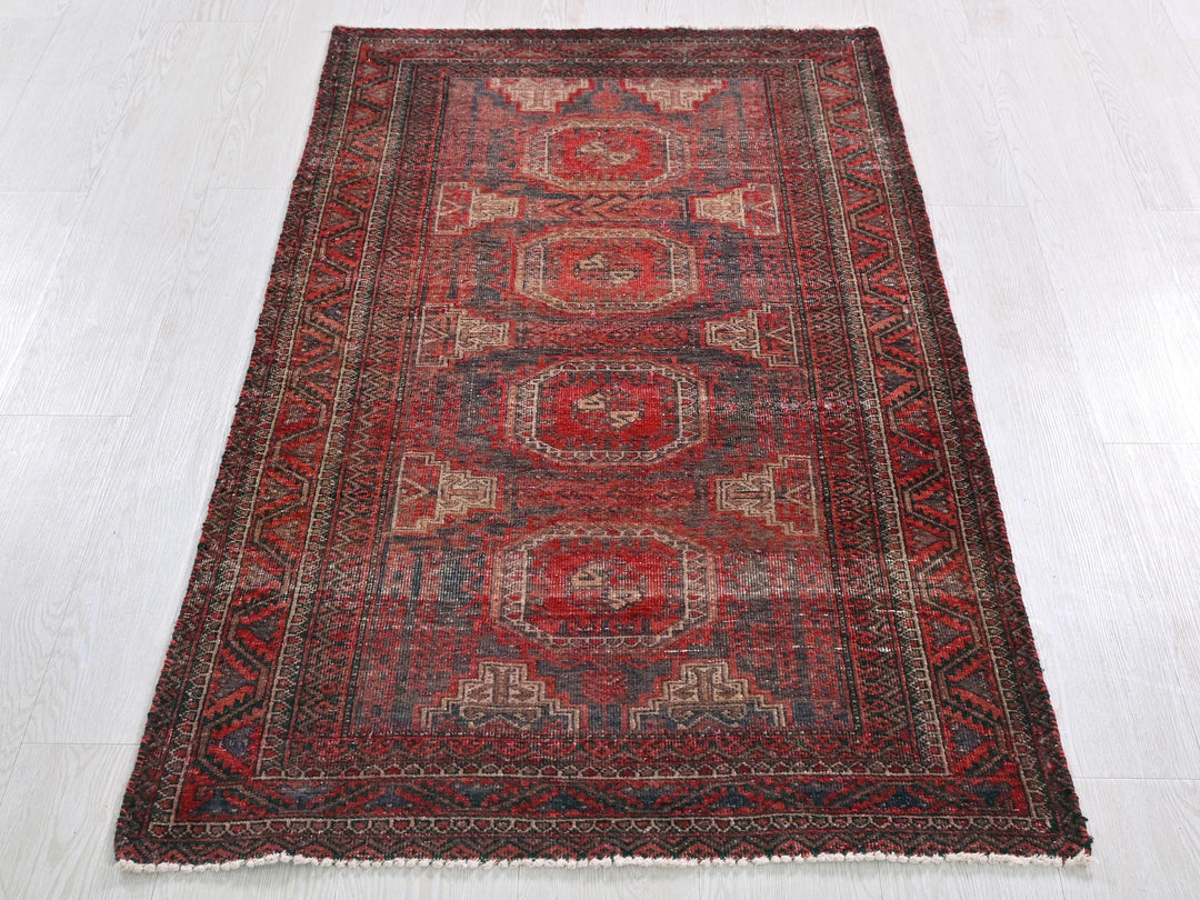 a red oriental rug on a white floor