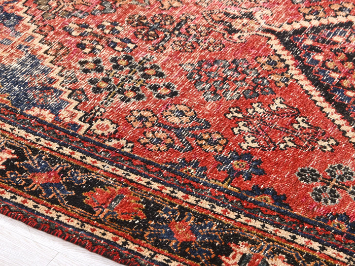 a red rug with a blue and red design on it
