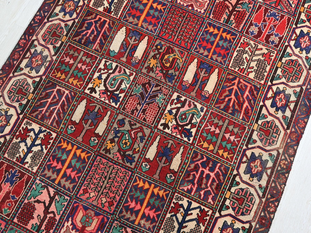 a red rug with many different designs on it
