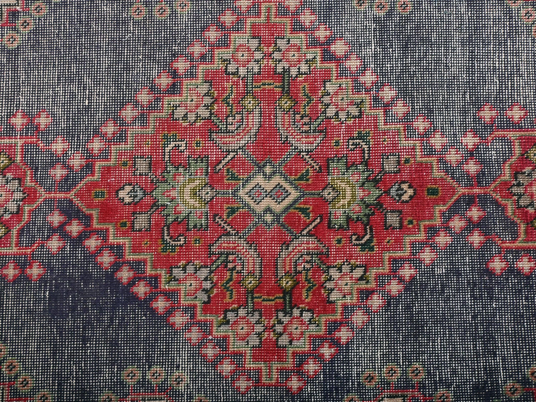 a blue and red rug with a pattern on it