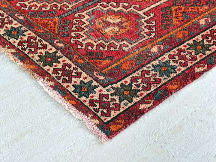 a red rug on a white wooden floor
