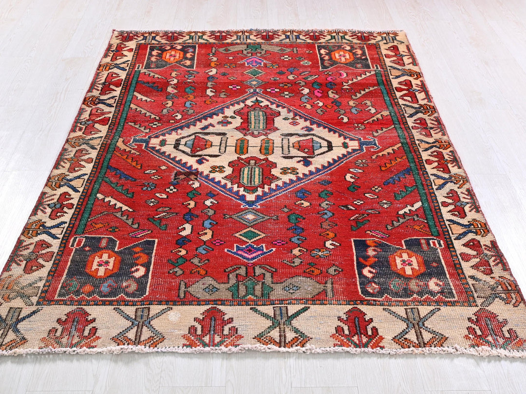 a red rug with a pattern on the middle of it