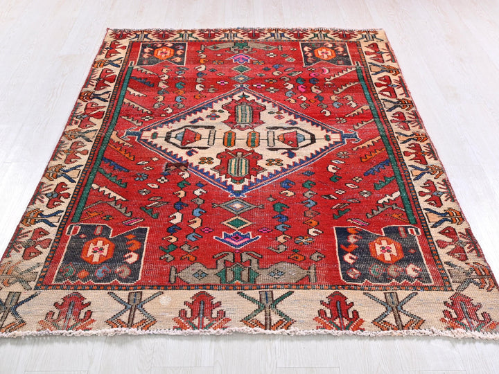 a red rug with a pattern on the middle of it