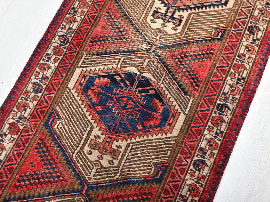 a red and blue rug on a white floor