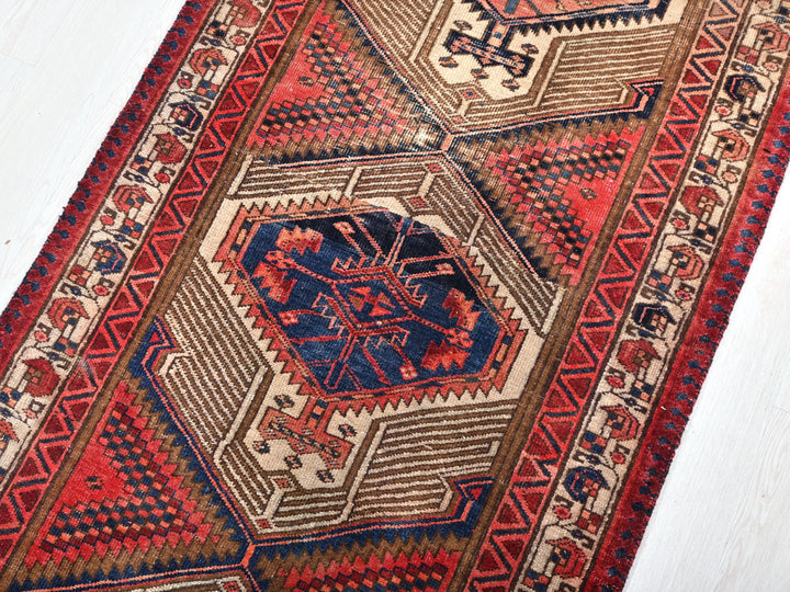 a red and blue rug on a white floor