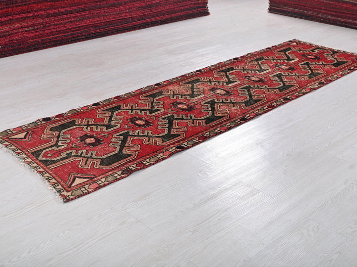 a red rug is laying on a white floor