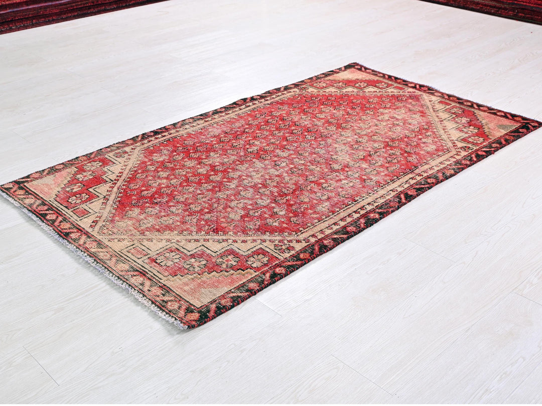 a red rug is laying on a white floor